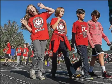  ?? PHOTOS BY PETE BANNAN-DIGITAL FIRST MEDIA ?? Students at French Creek Elementary School, above and below at left, take part in the school’s walkathon held on Oct. 18.