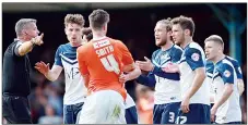  ??  ?? GET AWAY: Southend players remonstrat­e with referee Iain Williamson