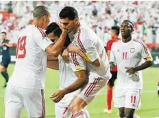  ?? Abdul Rahman/Gulf News ?? Team spirit UAE players celebrate after scoring against East Timor in the AFC Asian Cup preliminar­y qualifiers round two at Al Jazira Sports Club in Abu Dhabi.