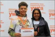  ?? MICHILEA PATTERSON — DIGITAL FIRST MEDIA ?? Aiden Weber, 15, poses for a photo alongside Stacey Woodland, YWCA Tri-County Area executive director, during a Race Against Racism 5K at Riverfront Park in Pottstown on Saturday. Weber, a Pottstown High School student, crossed the finish line first at...