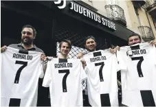  ?? AFP ; Getty ?? Juventus fans in Turin celebrate their new signing while, right, Cristiano Ronaldo after winning his fourth Champions League title with Real Madrid in May – the fifth of his career