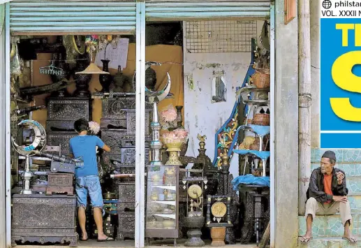  ?? REUTERS ?? OPEN FOR BUSINESS: A worker cleans up displayed antiques for sale in a store in Marawi yesterday. After five months of crippling conflict, life is slowly returning to the battered city.