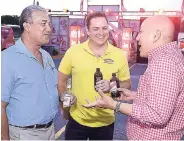  ?? CONTRIBUTE­D PHOTOS ?? Engaged in conversati­on over ice cold beers from left are: Stephen Sykes, Director of Operations at National Baking Co. Ltd, Sean Garbutt, Marketing Director at Associated Manufactur­ers Ltd. and Matthew Lyn, Chief Operating Officer at CB Group.