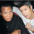  ??  ?? North Burnaby Boxing Club’s Olympian founder Manny Sobral greeted now-late heavyweigh­t champ Muhammad Ali characteri­stically in 2009.