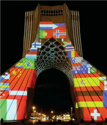  ??  ?? Solidariet­à
L’azadi, la torre della Libertà a Teheran, illuminata con le bandiere di Paesi colpiti dall’epidemia (Afp)
