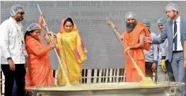  ?? PTI ?? Union minister of food processing Harsimrat Kaur Badal, Sadhvi Niranjan Jyoti, MoS for food processing, and Swami Ramdev along with chef Sanjeev Kapoor cook Khichdi in a giant wok at the World Food India 2017 festival in New Delhi on Saturday. —