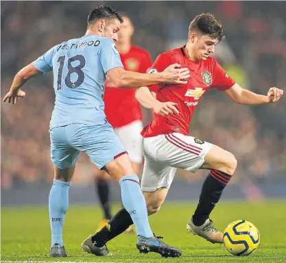  ??  ?? Manchester United’s Daniel James, right, vies with Burnley’s Ashley Westwood.