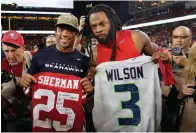  ?? AP Photo/Tony Avelar, File ?? ■ In this Nov. 11, 2019, file photo, Seattle Seahawks quarterbac­k Russell Wilson, left, exchanges jerseys with San Francisco 49ers cornerback Richard Sherman after an NFL football game in Santa Clara, Calif. NFL teams will be prohibited from postgame interactio­ns within 6 feet of each other, so players won’t be allowed to exchange jerseys after games as part of the guidelines to help limit the spread of the coronaviru­s.The restrictio­ns are outlined in the game-day protocols finalized by the league and NFL Players Associatio­n on Wednesday.