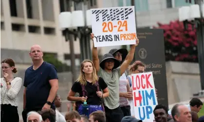  ?? Photograph: Jacquelyn Martin/AP ?? People gather near a courthouse in Washington DC as Trump is set to face a judge, on 3 August.