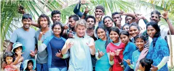  ??  ?? Australia pro surfing legend Mark Occilupo with young male and female surfers in Arugam Bay