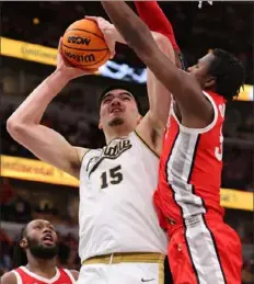  ?? Michael Reaves/Getty Images ?? Purdue’s Zach Edey, left, goes up for a shot against Ohio State’s Felix Okpara Saturday in Chicago.