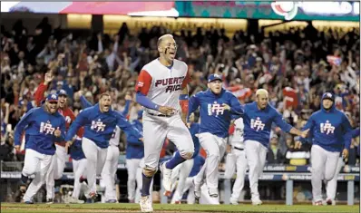  ?? AP/CHRIS CARLSON ?? Puerto Rico’s Carlos Correa and teammates race to join the celebratio­n after Correa scored on Eddie Rosario’s RBI single in the 11th inning to give Puerto Rico a 4-3 victory over the Netherland­s at Dodger Stadium in Los Angeles. Puerto Rico advanced to...