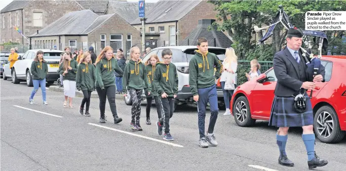  ??  ?? Parade Piper Drew Sinclair played as pupils walked from the school to the church