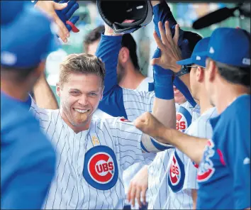  ?? TERRENCE ANTONIO JAMES/CHICAGO TRIBUNE ?? Nico Hoerner is congratula­ted after hitting a home run against the Pirates.