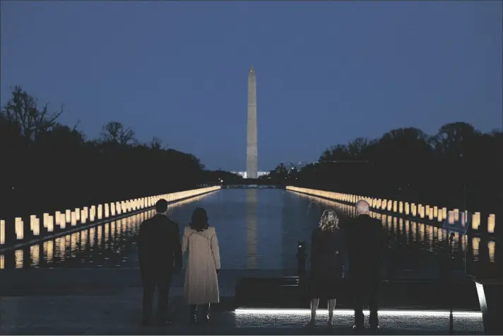  ?? ASSOCIATED PRESS ?? PRESIDENT-ELECT JOE BIDEN and his wife Jill Biden are joined by Vice President-elect Kamala Harris and her husband Doug Emhoff during a COVID-19 memorial event at the Lincoln Memorial Reflecting Pool on Tuesday in Washington.