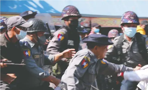  ?? STR/AFP VIA GETTY IMAGES ?? Myanmar police arrest a protester on Friday at a demonstrat­ion in Mawlamyine, Mon State, against the country's military coup.