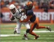  ?? ADRIAN KRAUS - THE ASSOCIATED PRESS ?? Louisville wide receiver Chatarius Atwell, left, is tackled by Syracuse defensive back Antwan Cordy during the first half of an NCAA college football game in Syracuse, N.Y., Friday, Nov. 9, 2018.