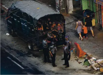  ?? PHOTOS BY THE ASSOCIATED PRESS ?? Security forces stand by in the Kamayut township of Yangon in Myanmar on Monday. The military overthrew the elected government, jailed Aung San Suu Kyi and other civilian leaders and killed and imprisoned protesters in the country.