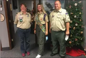  ?? (AP/Edmund Tunney) ?? Isabella Tunney, 16, pictured in October in Edina, Minn., with Bev Verweg, her scoutmaste­r, and Brian Reiners, a boys troop scoutmaste­r, is one of 1,000 girls and young women who will be honored for achieving the rank of Eagle Scout.