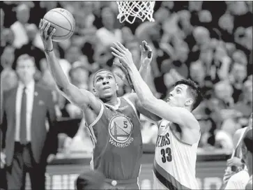  ?? Jonathan Ferrey Getty Images ?? KEVON LOONEY and the rest of the Warriors’ bench had to rise to the occasion against Zach Collins and the Trail Blazers after their already short-handed team lost Andre Iguodala to a leg injury in Game 3.