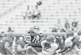  ?? Brett Coomer / Houston Chronicle ?? Quarterbac­k Kyle Allen, center, a transfer from Texas A&M, was 12-of-18 passing with a touchdown and two intercepti­ons during Saturday’s spring game.