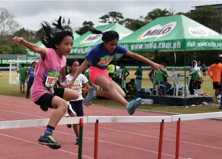  ?? Photo by Redjie Melvic Cawis ?? OLYMPIC DREAMS. High school students try to outrun their competitio­n in the 100-meters hurdles event during the Milo Little Olympics in Baguio City.