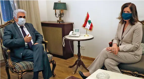  ?? AP ?? Lebanese Foreign Minister Nassif Hitti, left, discusses current developmen­ts and bilateral relations between the two countries with US Ambassador to Lebanon Dorothy Shea, in Beirut on Monday.