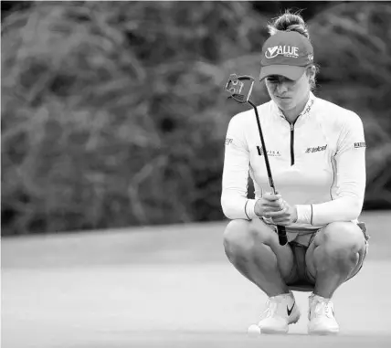  ?? REBECCA BLACKWELL/AP ?? Gaby Lopez of Mexico lines up a putt on the eighth hole during the final round of the LPGA Tour Championsh­ip in November in Naples. Lopez has a 1-shot lead after the first day in the Hilton Grand Vacation Tournament of Champions at Lake Nona Golf and Country Club Thursday.