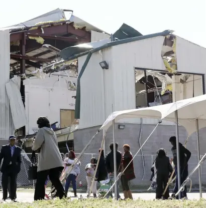  ?? AP ?? SAYING THEIR PRAYERS: People leave a service at Mount Bethel Missionary Baptist Church Sunday, in Nashville, Tenn. The congregati­on held their service in a tent in the parking lot near the church facilities, which were heavily damaged by a tornado March 3.