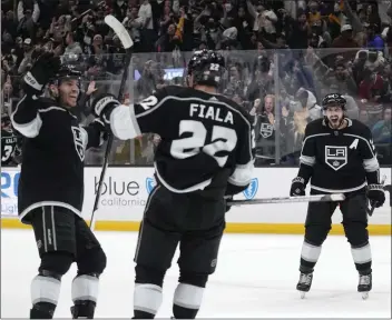  ?? MARK J. TERRILL — THE ASSOCIATED PRESS ?? The Kings’ Kevin Fiala, center, celebrates his OT goal against Chicago with Matt Roy, left, and Phillip Danault, right.