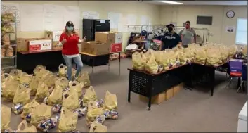  ?? Courtesyph­oto ?? Basic Needs Team members assist with distributi­on preparatio­n in May, led by Campus Safety’s Gina Madrid, Rafael Montano, and Genaro Ayala.