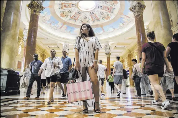  ?? Benjamin Hager Las Vegas Review-Journal @benjaminhp­hoto ?? Shihana Abulebdeh shopped on a recent afternoon at the Forum Shops, which has more than 160 retailers and restaurant­s.