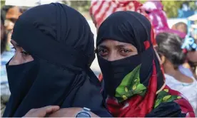  ?? Photograph: Shafiqur ?? Rohingya refugees who are being moved to Bhasan Char gather outside a transit area where they are being temporally housed in Ukhiya, Bangladesh.