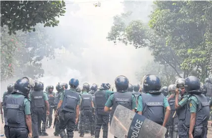  ?? EPA-EFE ?? Police fire tear gas grenades and disperse student protesters during the eight-day protest demanding safer roads in Dhaka, Bangladesh.