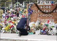  ?? ERIC GAY/AP FILE ?? Reggie Daniels pays respects at Robb Elementary June 9, 2022, in Uvalde, Texas, where 19 children and two teachers died. With more than 30 million people, Texas defies cliches, but even conservati­ve gun owners are uneasy about mass shootings.