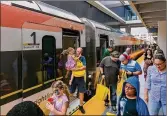  ?? GREG LOVETT / THE PALM BEACH POST ?? Brightline passengers exit the train in West Palm Beach from Miami on May 19 on the first day of service for the route. Efforts for a West Palm-to-Orlando leg continue.