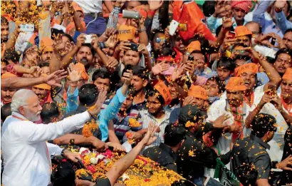  ?? AFP ?? Prime Minister Narendra Modi gestures during a road show during an election rally in Varanasi. —