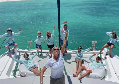  ??  ?? The Heffner clan and their mates from Cohasset, Massachuse­tts, donned matching crew shirts for the obligatory team photo during their Moorings charter last spring in the BVI, but chef Linzi couldn’t help photo-bombing the scene.