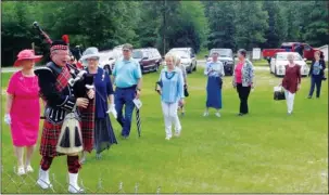  ?? Submitted photo ?? A SCOTTISH TOUCH: Dr. George English III leads attendees to the grave site of Duncan Munn as he played “Amazing Grace” on the bagpipes.