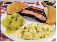  ??  ?? Arkansas Democrat-Gazette/ROSEMARY BOGGS A rib dinner special is served with potato salad, tomato relish and a toasted bun at the Smoke Shack in Maumelle.