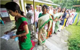  ?? / AP ?? FIRST ROUND. People stand in queue to cast their votes during the first round of polling of India’s national election in Bahona village, Jorhat, northeaste­rn Assam, India on Friday, April 19, 2024.