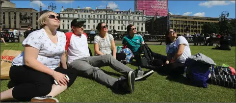  ??  ?? People soaked up the sun as summer weather arrived in George Square, Glasgow. Pictured from left are Claire Illingwort­h, Chris Mathieson, Mikaela Kennedy, Adam Robertson and Liz Allan. Picture: Colin Mearns