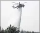  ?? LEFTERIS PITARAKIS — THE ASSOCIATED PRESS ?? An helicopter drops water over a fire in Galatsonas village on Evia island, about 115 miles north of Athens, Greece, Wednesday.