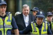  ?? AP PHOTO/ASANKA BRENDON RATNAYAKE, FILE ?? FILE - Cardinal George Pell, center, the most senior Catholic cleric to face sex charges, leaves court in Melbourne, Australia, May 2, 2018. Pell, who was the most senior Catholic cleric to be convicted of child sex abuse before his conviction­s were later overturned, has died Tuesday, Jan. 10, 2023, in Rome at age 81.