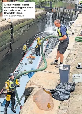  ?? PHOTO: COLIN WAREING ?? A River Canal Rescue team refloating a sunken narrowboat on the Rochdale Canal.