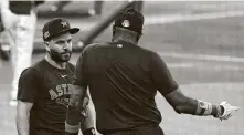  ??  ?? Jose Altuve talks with manager Dusty Baker during the Astros’ summer camp at Minute Maid Park on Wednesday.