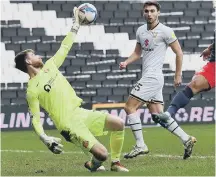  ??  ?? Lee Burge makes a one handed save against MK Dons.