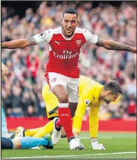  ??  ?? DIFFERENT MAN: Walcott celebrates his opener