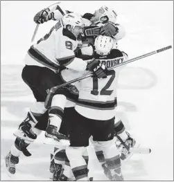  ?? RHONA WISE REUTERS ?? Devils centre Adam Henrique is mobbed by teammates Zach Parise (left), Alexei Ponikarovs­ky and David Clarkson after scoring in double OT to defeat the Panthers.