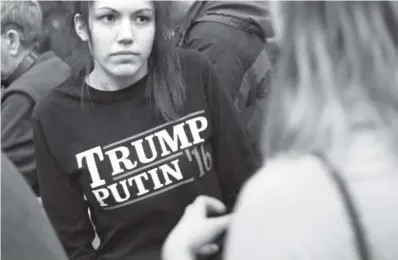  ??  ?? A woman waits for Republican presidenti­al candidate Donald Trump to speak at a Feb. 7 campaign event in Plymouth, N.H. Associated Press file